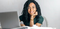 Freundliche junge Frau mit Laptop